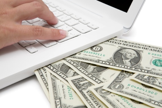 Cash Coming Out of a Computer - Photo courtesy of ©iStockphoto.com/JoKMedia, Image #13923134 Cash Coming Out of a Computer - Photo courtesy of ©iStockphoto.com/JoKMedia, Image #13923134